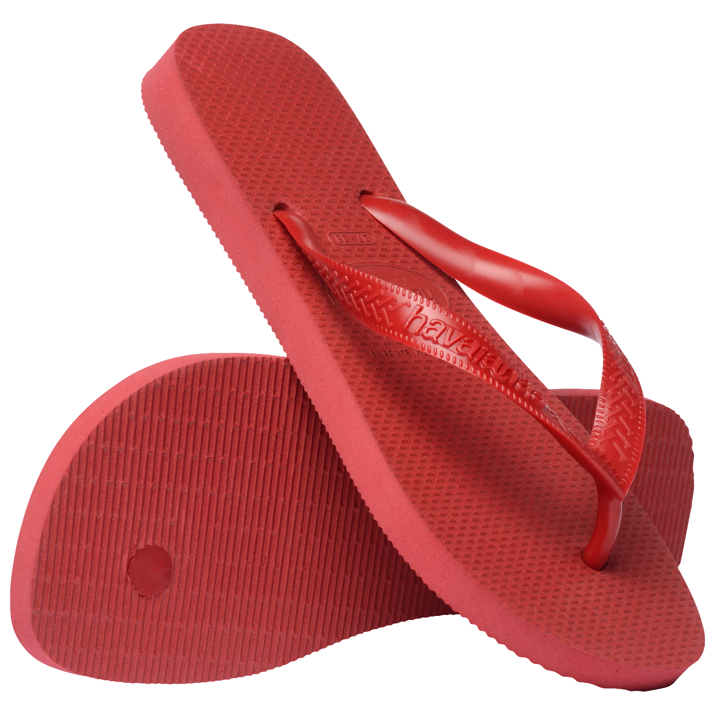 Par de chinelos Havaianas vermelhos posicionados cruzados, exibindo solado antiderrapante e tiras vermelhas com textura em destaque sobre fundo branco.