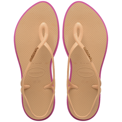 Chinelo Havaianas rosa com sola bege e detalhes dourados, conforto e estilo para o dia a dia.